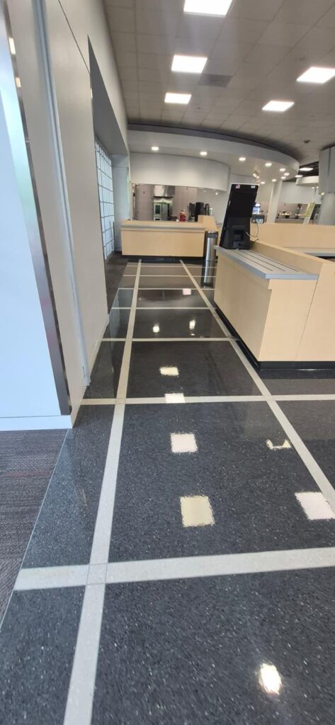 Completed floor stripping and waxing project in a campus food court