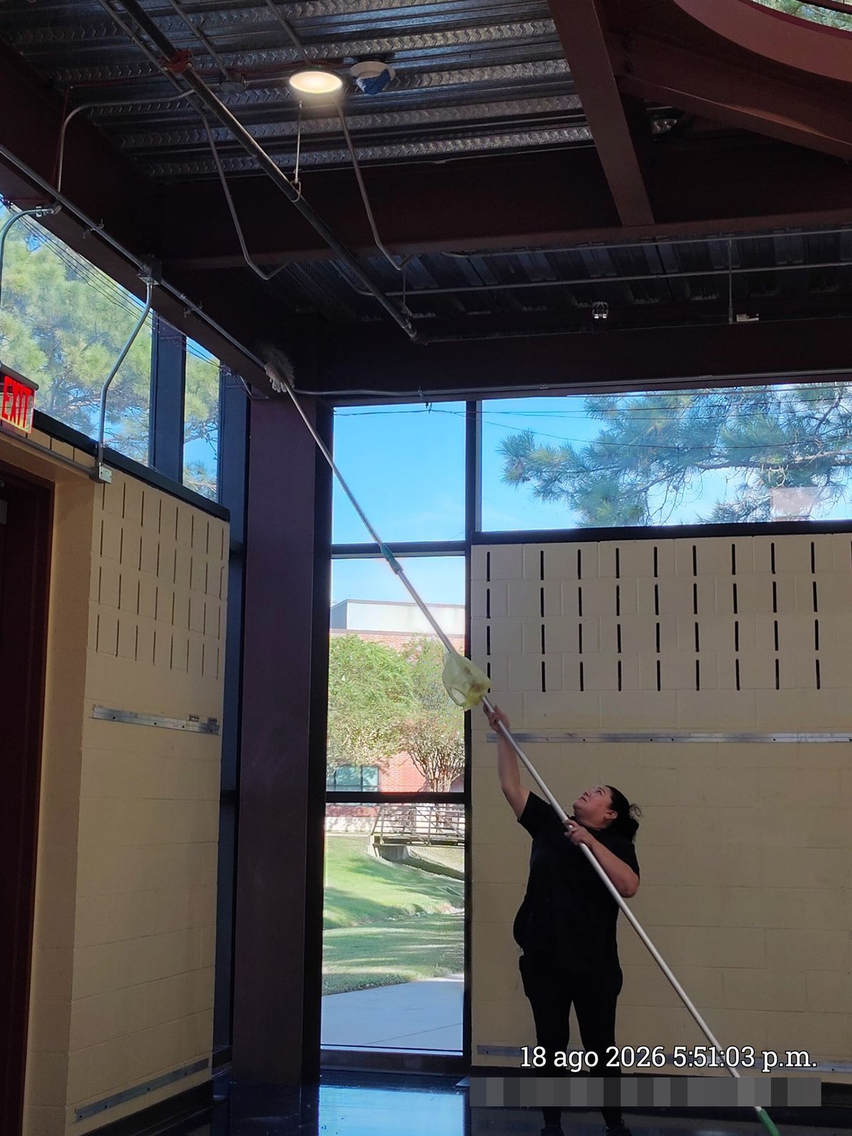Technician high dusting ceiling beams with extension pole