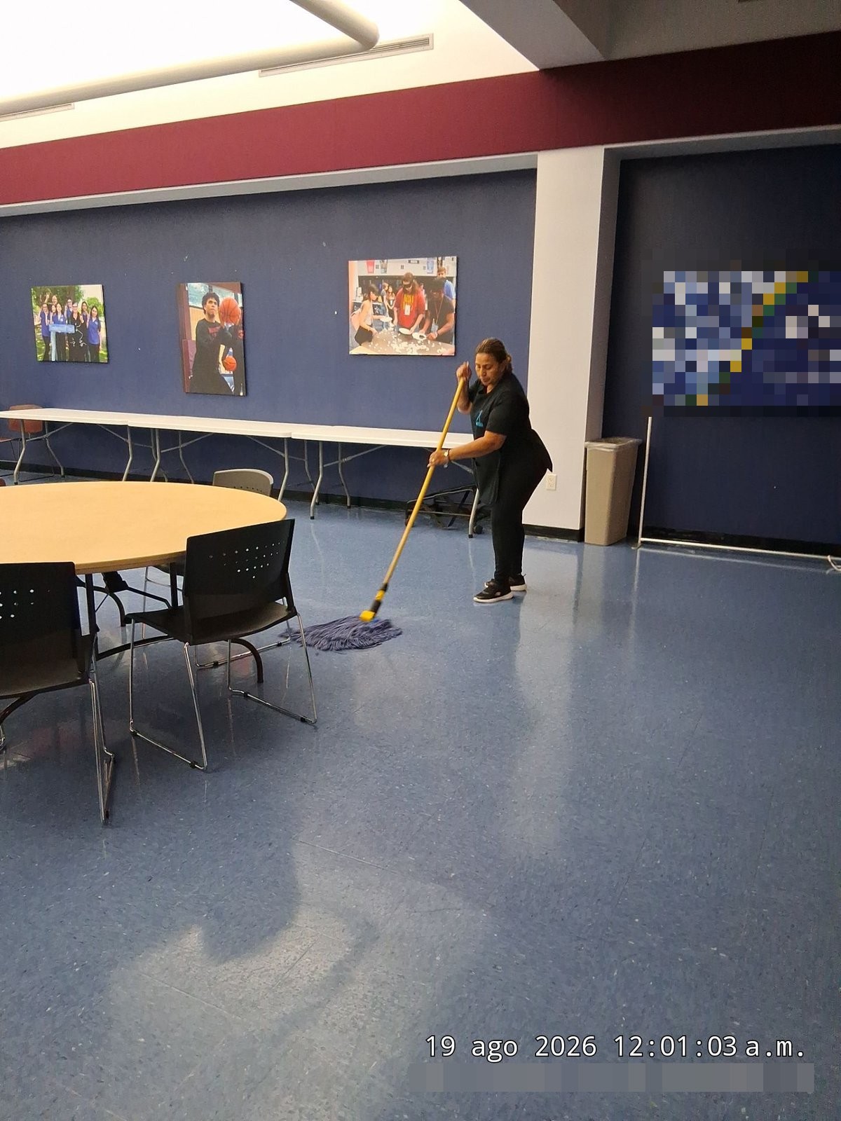 Janitor damp mopping VCT floors in a Houston commercial facility