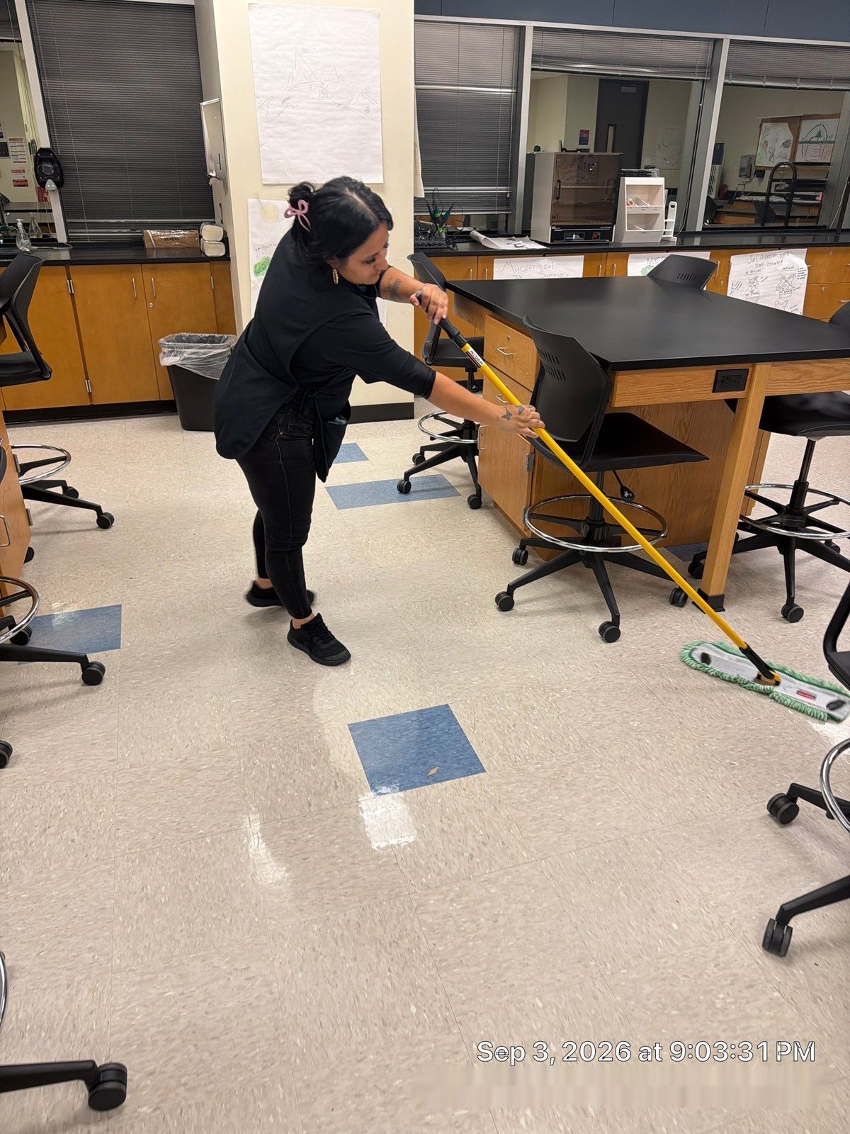 Caring Commercial Cleaning team member mopping a school science lab floor